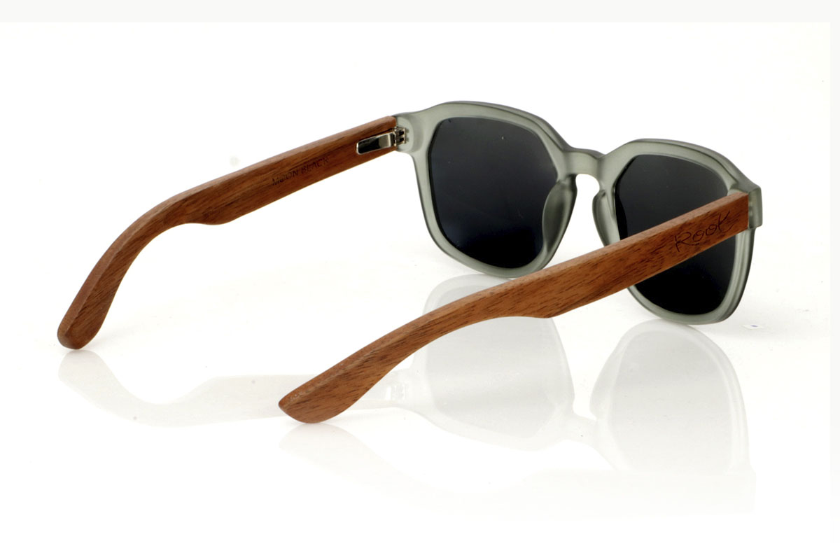 Wood eyewear of Walnut MOON BLACK. The MOON BLACK are your new favorite sunglasses, with a hexagonal PC frame in matte transparent gray and walnut wood temples. Perfect for those looking for a special touch in their daily life, these glasses mix design and nature in a unique way. Comfortable to wear and great for seeing everything in a new light, they adapt to any look and occasion. Moon black are the ideal complement for any face. Try them and feel how they complement your style. Front measurement: 148x50mm. Caliber: 53 for Wholesale & Retail | Root Sunglasses® 